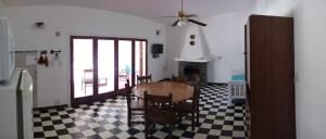 a living room with a table and chairs and a fireplace at Villa Coca -Los Jilgueros- in Villa la Bolsa