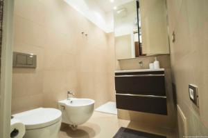 a bathroom with a white toilet and a sink at Toffee Mombello - Seven Suites Sanremo in Sanremo +38 photos