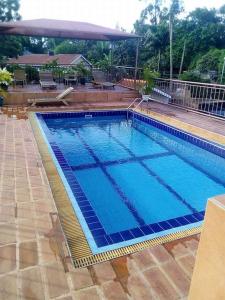 a large swimming pool with blue water at Go around Kampala all day to return to your wonderful apartment in Kampala