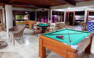 a pool table in the middle of a room at BOULEVARD DA PRAIA Apart Hotel Beira mar in Porto Seguro