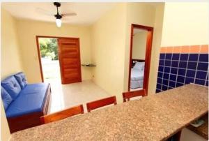 a living room with a blue couch and a table at BOULEVARD DA PRAIA Apart Hotel Beira mar in Porto Seguro