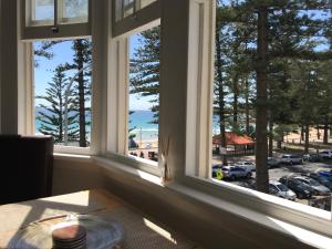 a window with a view of a parking lot at Manly Beach Stays in Sydney