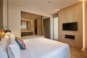Postel nebo postele na pokoji v ubytování Pan Pacific Serviced Suites Orchard, Singapore