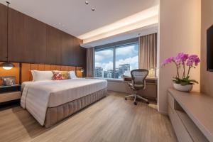 Postel nebo postele na pokoji v ubytování Pan Pacific Serviced Suites Orchard, Singapore