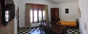 a room with a table and a bed and a window at Villa Coca-Los Agapantos- in Villa la Bolsa