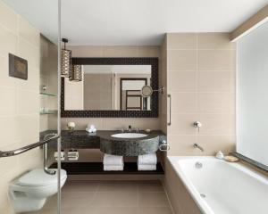 a bathroom with a sink, toilet and bathtub at Shangri-La Tanjung Aru, Kota Kinabalu in Kota Kinabalu
