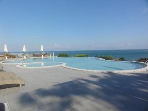 a swimming pool with the ocean in the background at High Life Bungalow in Haad Yao