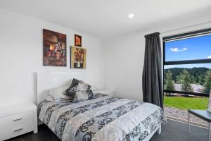- une chambre avec un lit et une grande fenêtre dans l'établissement Mapua View - Mapua Holiday Unit, à Mapua