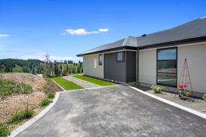 a house with a driveway in front of it at Mapua View - Mapua Holiday Unit in Mapua