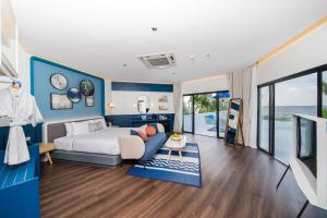 a bedroom with a bed and a couch and a tv at Kram Pattaya in Pattaya North +69 photos