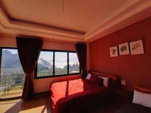 a bedroom with a bed and a large window at Homestay 715 in Sa Pa