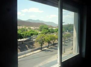 a window with a view of a city street at Hotel Ruma in Salta