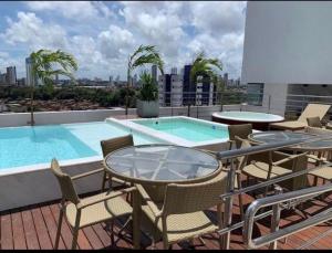 a balcony with a swimming pool on top of a building at Magnífico Flat no melhor de Manaíra - Apart Hotel in João Pessoa