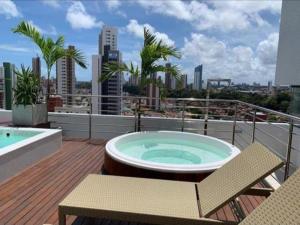 a hot tub on the deck of a building at Magnífico Flat no melhor de Manaíra - Apart Hotel in João Pessoa