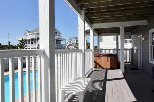 a porch with a bench and a swimming pool at Paradise Retreat #21-OI in Avon