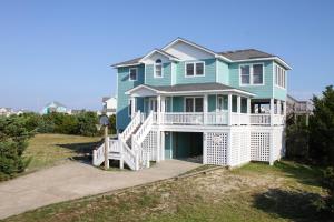 a large green house with a white porch at Pamlico Sunset #8-9 in Avon