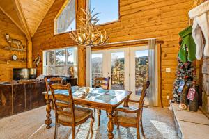 a dining room with a table and chairs and a christmas tree at Jiji & Toto's in Pagosa Springs