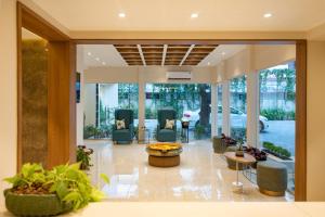 a lobby of a house with chairs and a table at Time Square Boutique Hotel & Spa in Alleppey