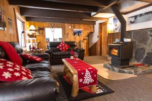 a living room with a couch and a stove at Red Shutter Inn in Rossland