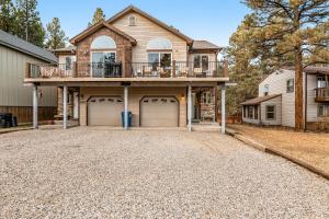a house with two garage doors and a balcony at The Lakeview Escape in Pagosa Springs