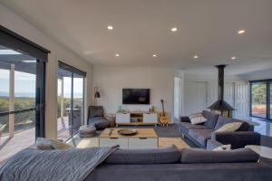 a living room with a couch and a table at NOR'EAST Beaumaris in St Helens