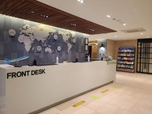 a front desk of a store with a map of the world at Tamara Jeju hotel in Seogwipo