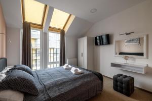 a bedroom with a bed and a large window at City Aparts Kulisha Str in Lviv