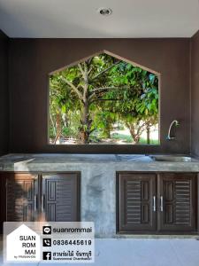a window above a kitchen counter with a sink at Suan Rom Mai Chanthaburi สวนร่มไม้ จันทบุรี in Khlung
