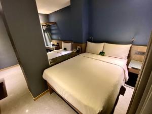 a bedroom with a large white bed in a room at Beauty Hotels Taipei - B7 Journey in Taipei