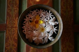 a bowl with flowers in it on a wall at Sea Heart House on Koggala Lake in Koggala