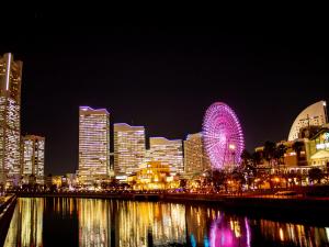 a city skyline with a ferris wheel at night at TATAMI l in Yokohama