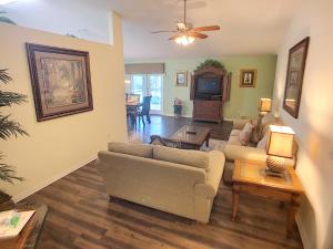 a living room with two couches and a tv at Rocco's Retreat in Orlando