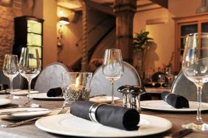 a table with plates and wine glasses on it at Hotel Herrnschloesschen in Rothenburg ob der Tauber