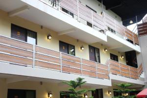 a large building with wooden balconies and lights at Bamboe Inn 2 Homestay in Tanjungkarang