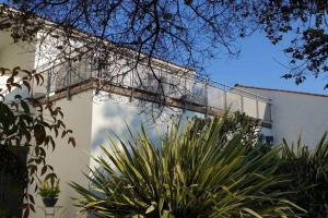 a white building with a balcony on the side of it at L'APPART' in Vaux-sur-Mer