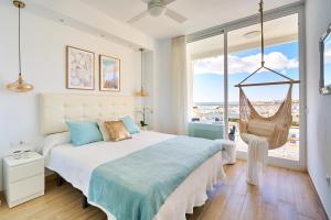 sypialnia z huśtawką i dużym oknem w obiekcie SUNSET BEACH Charming apartment with jacuzzi w mieście Torremolinos