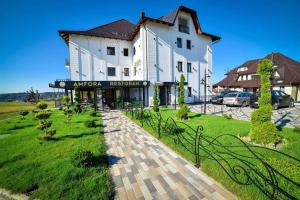 a large white building with a sign in front of it at Adonis Zlatibor 205 in Zlatibor