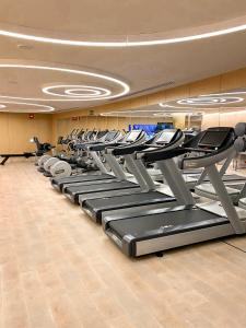 a gym with a row of treadmills and machines at Four Seasons Hotel Madrid in Madrid