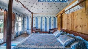 a bedroom with a bed and chairs in a room at Maa Ashapura Resort in Sawāi Mādhopur +78 photos