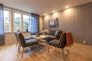 a living room with a couch and chairs and a table at Kläppen Ski Resort in Transtrand