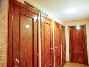a bathroom with a door open and a wooden floor at Kione Calgary in Pas de la Casa