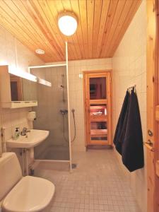 a bathroom with a shower and a toilet and a sink at Gold Legend Paukkula #1 - Saariselkä Apartments in Saariselka