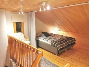 a bedroom with a bed and a wooden ceiling at Gold Legend Paukkula #1 - Saariselkä Apartments in Saariselka