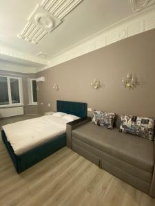 a bedroom with a large bed and a large window at Heart Kiev Apart-Hotel in Kyiv