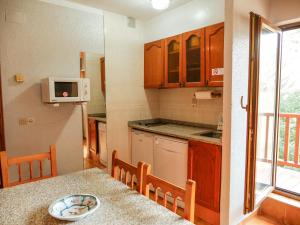 a kitchen with a table with a bowl of food on it at Kione DeuSol in Incles