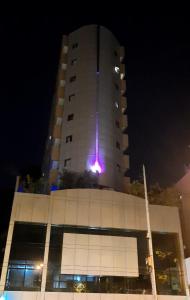 a building with a purple light on the top of it at Arpoador Premium Suítes in Rio de Janeiro