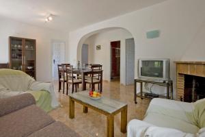 a living room with a couch and a tv at Villa Paolo in Calpe