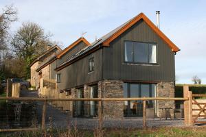 a house is shown with a fence in front of it at Creber Cottage in Totnes