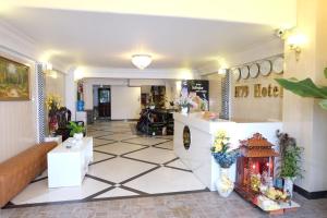 a lobby with a tile floor and a room with a fireplace at H79 HOTEL in Ho Chi Minh City