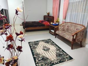 a living room with a couch and a rug at Bukittinggi Homestay 2 in Bukittinggi